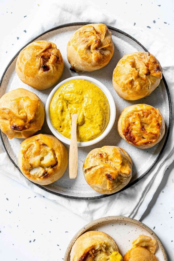 Nothing beats a classic potato knish. Make your own at home with this recipe, complete with jammy onions and flaky crust. Serve as a side dish, appetizer, or snack with deli mustard. #appetizer #easyappetizer #partyappetizer #partysnacks #appetizerideas
