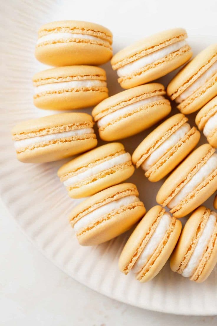 These French macarons are delicious, delicate, and bursting with bright lemon flavor. Make a batch for afternoon tea, a holiday cookie tray or brunch. #dessert #easydesserts #dessertideas